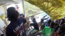 Migrants and crew are seen on the ship Lifeline while the Malta Armed Forces deliver aid, near Malta in International Waters June 23, 2018 in this still image taken from a video obtained from social media. PHOTO BY REUTERS/MISSION LIFELINE