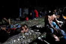Members of a caravan of thousands of migrants from Central America en route to the U.S, rest after a clash with the Mexican Police near the border gate, with the intention to carry on their journey, in Tecun Uman, Guatemala, October 28, 2018. PHOTO BY REUTERS/Carlos Garcia Rawlins