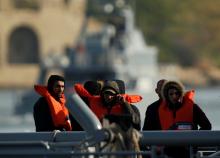 Rescued migrants wait to disembark from an Armed Forces of Malta (AFM) patrol boat after it rescued 87 migrants, at the AFM's base at Haywharf in Valletta's Marsamxett Harbour, Malta, March 6, 2019. PHOTO BY REUTERS/Darrin Zammit Lupi