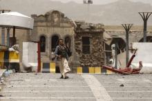 A Houthi militant walks past a building of the Defence Ministry compound damaged by a Saudi-led air strike in Yemen's capital Sanaa, June 10, 2015. PHOTO BY REUTERS/Khaled Abdullah