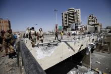 Houthi militants stand at the site of a Saudi-led air strike which targeted a tunnel leading to the presidential house near the Petrol Station in Yemen's capital Sanaa, October 1, 2015. PHOTO BY REUTERS/Mohamed al-Sayaghi