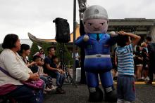 A performer dressed in a military honour guard mascot costume dances during a public fair which displays military equipments, in Taipei, Taiwan, September 29, 2018. PHOTO BY REUTERS/Tyrone Siu