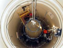 A US Air Force missile maintenance team removes the upper section of an intercontinental ballistic missile with a nuclear warhead in an undated USAF photo at Malmstrom Air Force Base, Montana. PHOTO BY REUTERS/USAF/Airman John Parie