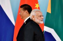 Chinese President Xi Jinping (L) and Indian Prime Minister Narendra Modi attend the group photo session during the BRICS Summit at the Xiamen International Conference and Exhibition Center in Xiamen, Fujian Province, China, September 4, 2017. PHOTO BY REUTERS/Kenzaburo Fukuhara