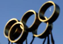 The moon is pictured through a sculpture in front of the International Olympic Committee (IOC) headquarters in Lausanne, December 9, 2009. PHOTO BY REUTERS/Denis Balibouse