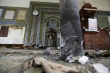 A Houthi militant stands inside the al-Balili mosque after two bombings hit the mosque in Yemen's capital Sanaa, September 24, 2015. PHOTO BY REUTERS/Khaled Abdullah