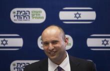 Naftali Bennett, smiles during a Jewish Home party meeting, at the Knesset, the Israeli parliament, in Jerusalem