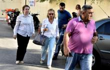Turkish journalist Nazli Ilicak (C), also a well-known commentator and former parliamentarian, is escorted by a police officer (R) and her relatives (L and rear) after being detained and brought to a hospital for a medical check in Bodrum, Turkey, July 26, 2016. PHOTO BY REUTERS/Kenan Gurbuz
