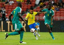 Brazil's Neymar in action with Senegal's Salif Sane. PHOTO BY REUTERS/Feline Lim