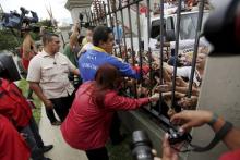 Venezuela's President Nicolas Maduro salutes the people through a fence before his vote in a polling center in Caracas, June 28, 2015. PHOTO BY REUTERS/Jorge Dan Lopez