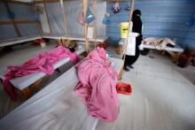 A nurse walks by women being treated at a cholera treatment center in the Red Sea port city of Hodeidah, Yemen, October 8, 2017. PHOTO BY REUTERS/Abduljabbar Zeyad