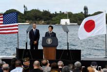 Japanese Prime Minister Shinzo Abe give remarks as U.S. President Barack Obama listens at Kilo Pier overlooking the USS Arizona Memorial at Joint Base Pearl Harbor-Hickam in Honolulu, Hawaii, U.S., December 27, 2016. PHOTO BY REUTERS/Hugh Gentry