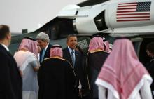 U.S. Secretary of State John Kerry (L) and U.S. President Barack Obama are greeted upon their arrival on Marine One for a meeting with Saudi King Abdullah at Rawdat al-Khraim (Desert Camp) near Riyadh in Saudi Arabia