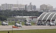 Four Sea Knight transport helicopters and a Super Stallion helicopter are parked at Marine Corps Air Station Futenma in Ginowan on Okinawa, May 3, 2010. PHOTO BY REUTERS/Toru Hanai