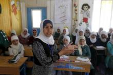 Syrian refugee Omayma al Hushan, 14, who launched an initiative against child marriage among Syrian refugees, speaks to her friends about her initiative at a school in Al Zaatari refugee camp in the Jordanian city of Mafraq, near the border with Syria, April 21, 2016. PHOTO BY REUTERS/Muhammad Hamed