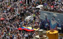 Opposition supporters take part in a rally against Venezuela's President Nicolas Maduro next to a poster of him in Caracas, Venezuela, October 26, 2016. PHOTO BY REUTERS/Christian Veron