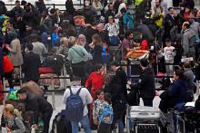 Passengers wait in the queue for check-in in the South Terminal building at Gatwick Airport, after the airport reopened to flights following its forced closure because of drone activity, in Gatwick, Britain, December 21, 2018. PHOTO BY REUTERS/Toby Melville
