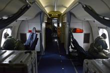 Naval aircrewmen assigned to Patrol Squadron (VP) 16 look for floating debris while on a P-8A Poseidon during search and rescue operations for Malaysia Airlines flight MH370