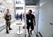 An Italian Army soldier patrols as a man walks through a metal detector in Taormina where leaders from the world's major Western powers will hold their annual summit, Italy, May 24, 2017. PHOTO BY REUTERS/Guglielmo Mangiapane