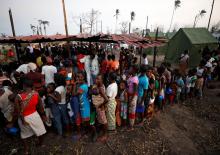 People queue for food in a camp for people displaced in the aftermath of Cyclone Idai in Beira, Mozambique, March 26, 2019. PHOTO BY REUTERS/Mike Hutchings