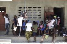 People wait to talk to an enumerator with The International Organization for Migration (IOM) at a camp for returned Haitians and Haitian-Dominicans, near the border between the Dominican Republic and Haiti, in Malpasse, August 3, 2015. PHOTO BY REUTERS/Andres Martinez Casares