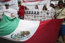 People hold a Mexican flag during a demonstration to demand information for the 43 missing students of the Ayotzinapa teachers' training college, in Iguala, the southern Mexican state of Guerrero, October 22, 2014. PHOTO BY REUTERS/Jorge Dan Lopez