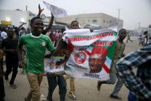 People jubilate along a street after All Progressive Congress (APC) candidate Muhammadu Buhari is pronounced the winner of Nigeria's presidential election, in Kano, March 31, 2015. PHOTO BY REUTERS/Akintunde Akinleye