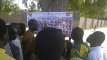 People look at pictures of wanted Boko Haram suspects on a notice posted by the Nigerian military, in Maiduguri, Borno State, Nigeria, November 13, 2015. PHOTO BY REUTERS/Stringer