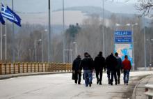 People cross the border zone at Promachonas border crossing between Greece and Bulgaria, Greece, February 17, 2016. PHOTO BY REUTERS/Stoyan Nenov
