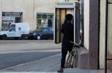 A man uses a public telephone booth along a street in Asmara, Eritrea February 20, 2016. PHOTO BY REUTERS/Thomas Mukoya