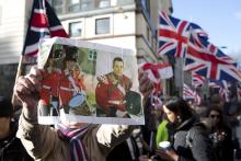 A demonstrator holds a picture of murdered soldier Lee Rigby during a protest outside the Old Bailey courthouse in London
