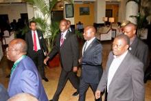 Burundi President Pierre Nkurunziza, (surrounded by security officers), is led by Tanzania Director General of Intelligence and Security Services, (DG-TISS), Rashid Othman (L), on his way to the Julius Nyerere International Airport in Dar es Salaam, Tanzania, May 13, 2015. PHOTO BY REUTERS/Stringer