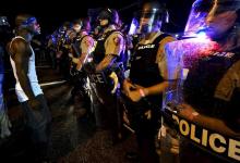 A protester yells at a police line shortly before shots were fired in a police-officer involved shooting in Ferguson, Missouri, August 9, 2015. PHOTO BY REUTERS/Rick Wilking