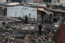 A police officer talks on his mobile phone while standing amidst the wreckage of houses destroyed in an explosion at the San Pablito fireworks market outside the Mexican capital on Tuesday, in Tultepec, Mexico, December 20, 2016. PHOTO BY REUTERS/Edgard Garrido
