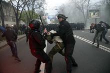 Ukrainian police try to stop a pro-Russian supporter from attacking a pro-Ukrainian rally in Donetsk, eastern Ukraine