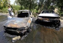 An Afghan policeman inspects damaged vehicles after a suicide attack in Jalalabad city, Afghanistan, July 10, 2018. PHOTO BY REUTERS/Parwiz