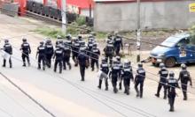 A still image taken from a video shows riot police walk along a street in the English-speaking city of Buea, Cameroon, October 1, 2017. PHOTO BY REUTERS TV
