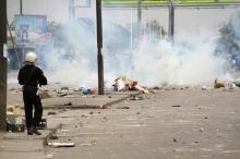 A policeman prepares to launch tear gas against protesters during a riot in a file photo. PHOTO BY REUTERS/Noel Kokou Tadegnon