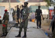 Policemen stand guard near Independent National Electoral Commission in Kano, March 29, 2015. PHOTO BY REUTERS/Goran Tomasevic