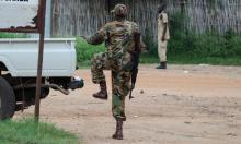 South Sudanese policemen and soldiers stand guard along a street following renewed fighting in South Sudan's capital Juba, July 10, 2016. PHOTO BY REUTERS/Stringer