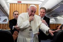 Pope Francis talks to journalists during a press conference on his return flight from Cairo to Rome, April 29, 2017. PHOTO BY REUTERS/Gregorio Borgia