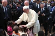 Pope Francis greets internally displaced children sheltered on the grounds of the Saint Sauveur church, during his visit in the capital Bangui, Central African Republic, November 29, 2015. PHOTO BY REUTERS/Siegfried Modola