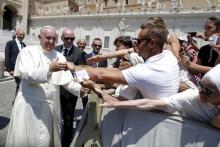 Pope Francis is greeted as he leaves at the end of the Wednesday general audience in Saint Peter's square at the Vatican June 10, 2015. REUTERS/Tony Gentile