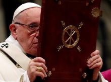Pope Francis holds the Book of the Gospels as he leads the Christmas Eve mass in Saint Peter's Basilica at the Vatican, December 24, 2018. PHOTO BY REUTERS/Max Rossi