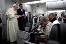 Pope Francis gestures as he speaks during a news conference aboard a plane on the way back from Panama to Rome, Italy, January 27, 2019. PHOTO BY REUTERS/Alessandra Tarantino