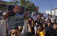 A protester holds up a poster of Yemen's former president Abd-Rabbu Mansour Hadi during an anti-Houthi demonstration in Sanaa, February 21, 2015. PHOTO BY REUTERS/Khaled Abdullah