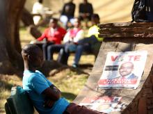 A man sits beside election posters of Nelson Chamisa's opposition MDC party in a park in central Harare, Zimbabwe, July 26, 2018. PHOTO BY REUTERS/Philimon Bulawayo