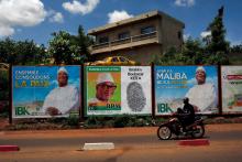A man rides his motorcycle next to the electoral bilibaords of Ibrahim Boubacar Keita, the Malian president and leader of RPM (Rassemblement Pour le Mali), in Bamako, Mali, July 23, 2018. PHOTO BY REUTERS/Luc Gnago