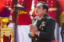 Thailand's Prime Minister Prayuth Chan-ocha prays before a military parade marking his retirement as commander in chief of the Royal Thai Army at the Chulachomklao Royal Military Academy in Nakornnayok