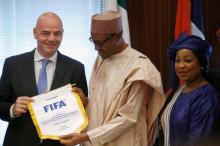 Nigerian President Muhammadu Buhari receives a present from FIFA President Gianni Infantino in Abuja, Nigeria, July 25, 2016. PHOTO BY REUTERS/Afolabi Sotunde